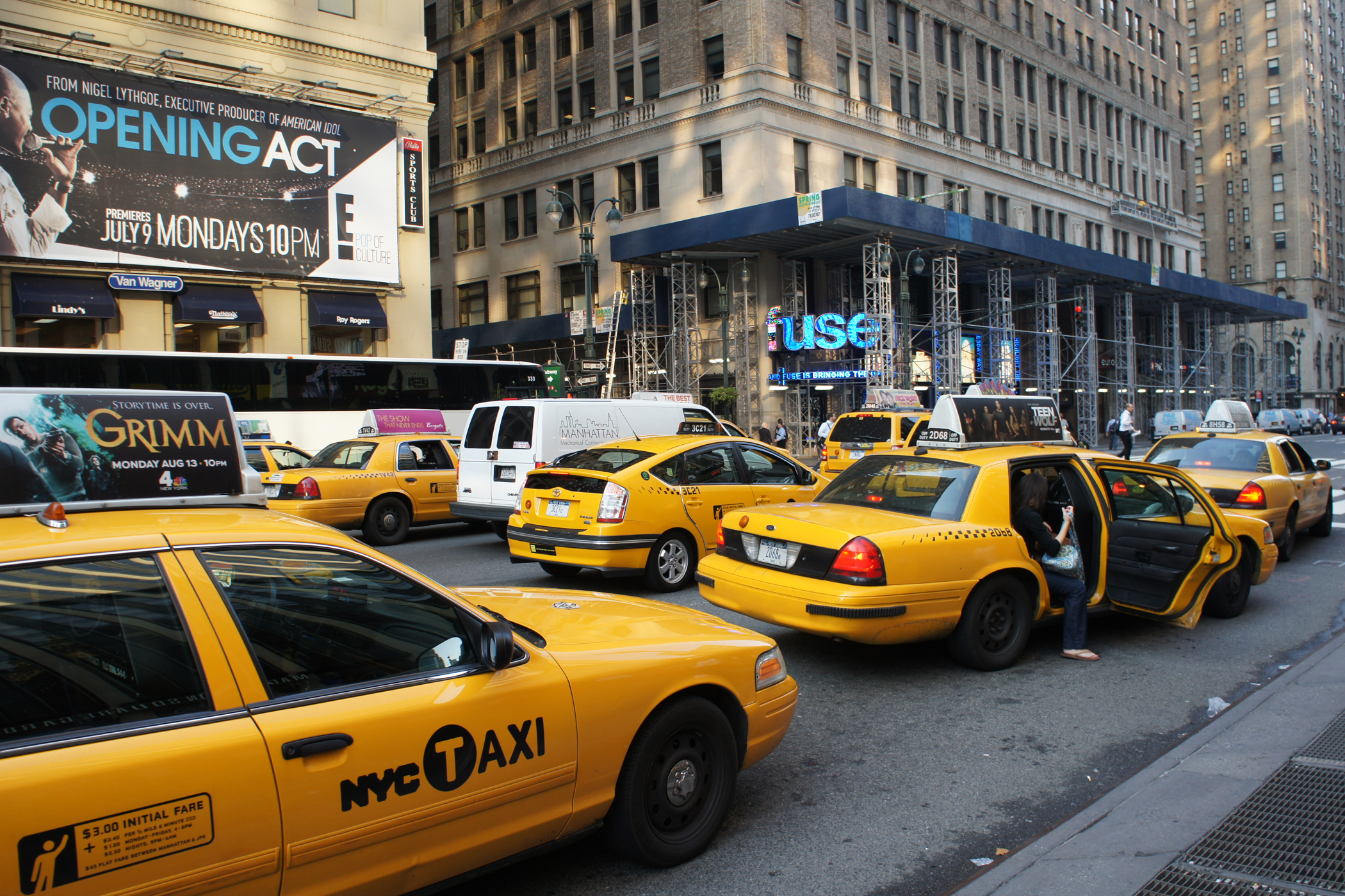 Image of yellow taxis in downtown New York City.